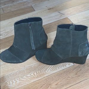 Pair of suede dark green boots. The brand is Toms